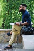 bearded man looking at a map photo