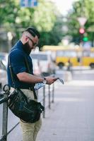 bearded man looking at a map photo