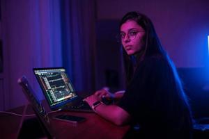 Attractive young woman working in home at night. photo