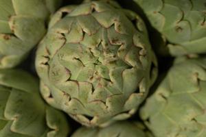 Several artichokes are photographed from above, in close up as a background and texture photo