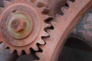 Close up of rusty gears interlocking on a machine photo