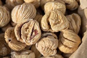 Close up and texture of dried chestnuts that are in a paper bag photo