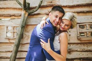 beautiful young wedding couple stands near house photo