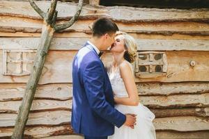 beautiful young wedding couple stands near house photo