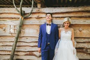 beautiful young wedding couple stands near house photo