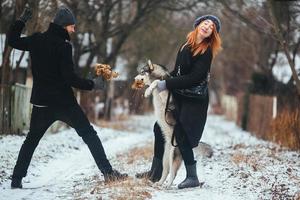 man and woman with dog walking photo