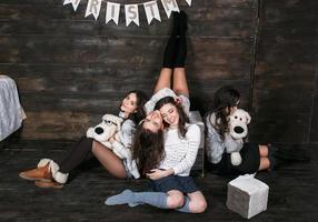 Four charming model posing on a vintage New Year's background photo