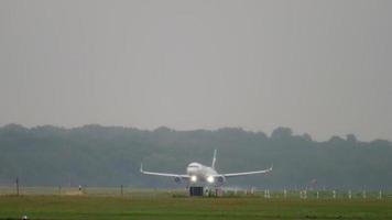 DUSSELDORF, GERMANY JULY 24, 2017 - Eurowings Airbus 320 D AEWL approaching and landing at rain. Dusseldorf airport video