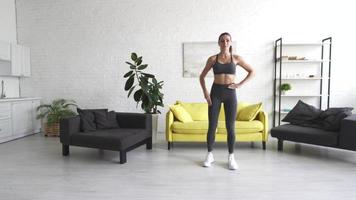 Beautiful young woman woman doing abdominal exercises in room photo