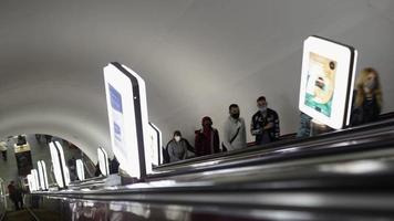 UKRAINE, KIEV - MAY 26, 2020 subway station. People go on the escalator in the metro. photo