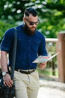 bearded man looking at a map photo