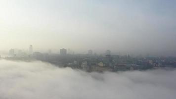 Aerial view of the city in the fog. photo