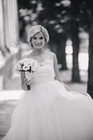 Young beautiful bride posing outdoors photo