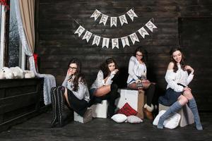 Four charming model posing on a vintage New Year's background photo