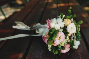 Wedding bouquet on a bench photo