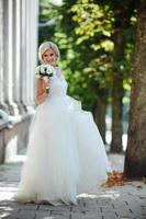 Young beautiful bride posing outdoors photo