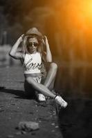 beautiful girl sitting on the pier photo