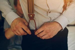 groom in the morning getting ready photo