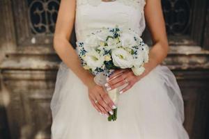 bride holding beautiful wedding bouquet photo