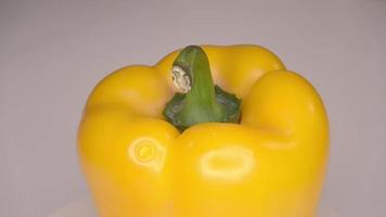 Loopable 4k footage of a single bell pepper spinning against a white background. video