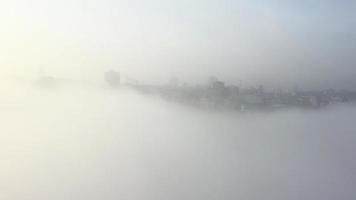 Aerial view of the city in the fog. photo