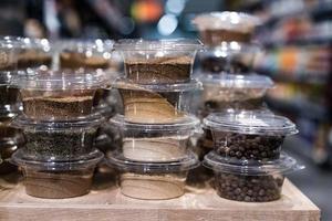 various spices and herbs packed in small transparent plastic boxes photo