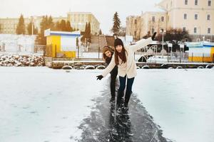 man and woman skate on ice photo