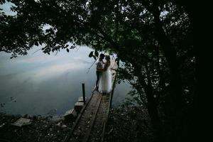 Wedding couple on the old wooden pier photo