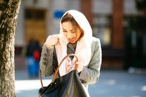 girl looking for something in a bag photo