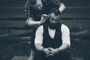 barber shaves a bearded man photo