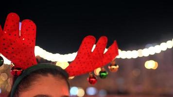 People enjoy ice skating in the street around Christmas tree in rink. photo