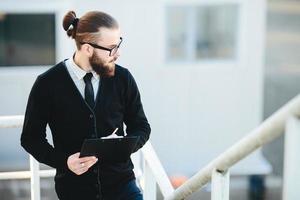 businessman stands with documents in hand photo