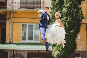 couple jumping on the street photo