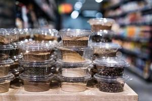 various spices and herbs packed in small transparent plastic boxes photo