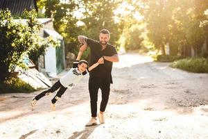 Dad plays with his little son on the photo