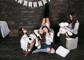 Four charming model posing on a vintage New Year's background photo