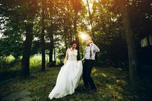 bride and groom dancing in nature photo