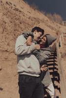 A man and a woman enjoy each other on the seashore. photo