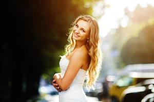 Beautiful bride posing against the backdrop of a European city photo