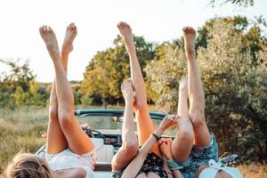 Three girls are lying on the trunk photo