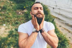 American Bearded Man touching his beard photo