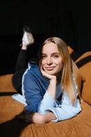 Beautiful young girl lying on the bed photo