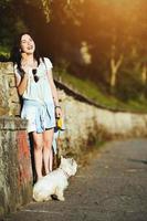 Girl with ice cream and dog photo