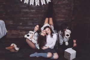 Four charming model posing on a vintage New Year's background photo