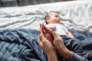 Baby's feet in hands photo