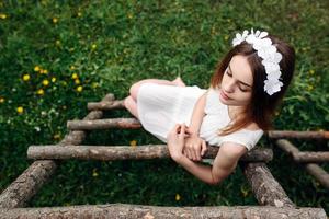 Lovely girl near a wooden house photo