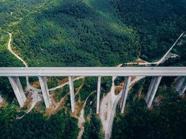 Aerial view of the road in the mountains over the bridge photo