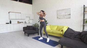 Beautiful young woman doing fitness at home photo