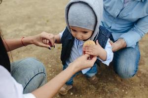 Happy young family with a little boy in nature photo