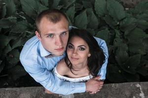 Young European couple cuddling on a park bench photo